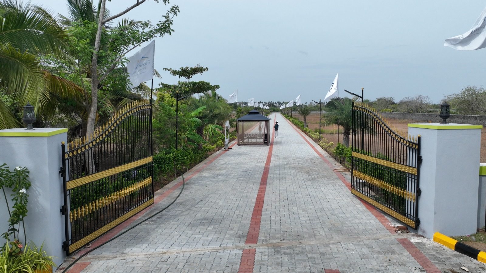 Wide internal road with compound wall at Mannvaasam Farms, ECR Mahabalipuram
